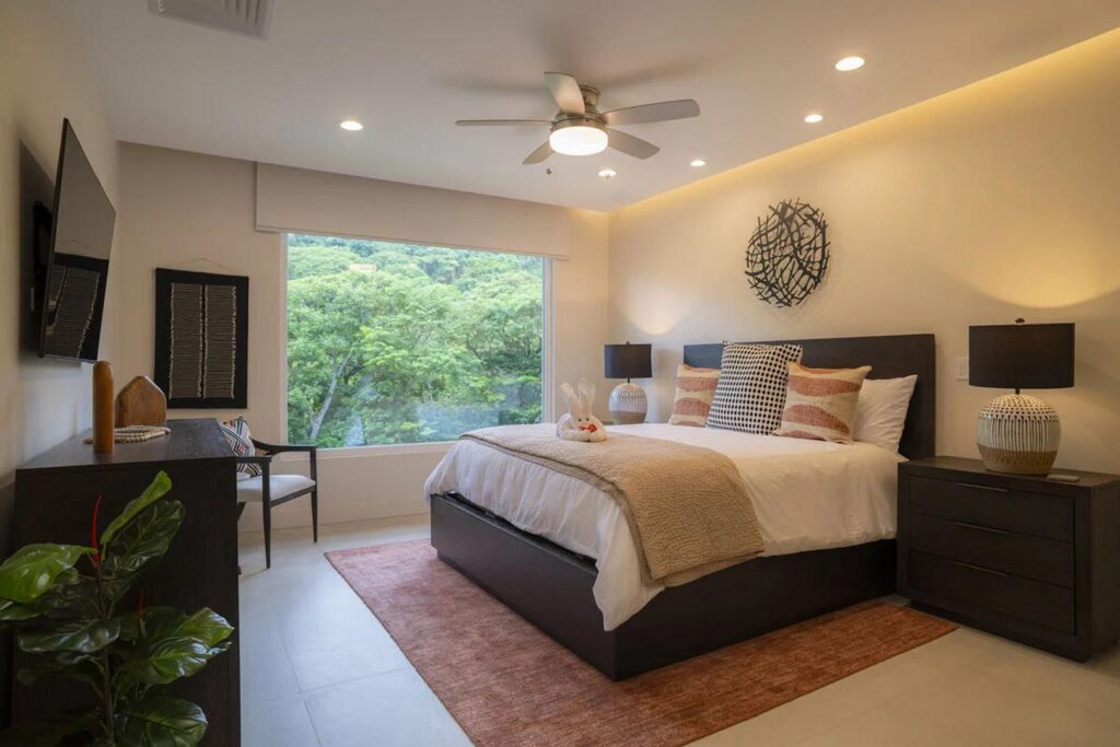 Thoughtful design and a large jungle-facing window make the master bedroom feel peaceful and bright.