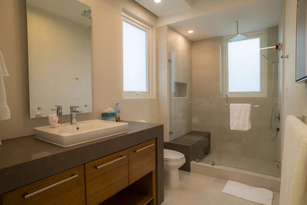 The bathrooms feature sleek stonework and a high-end finish.