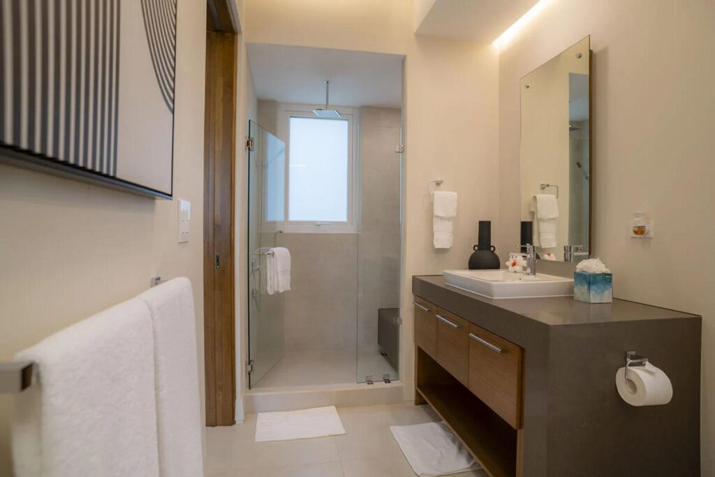 Rich wooden cabinetry brings warmth and elegance to the villa’s beautifully finished bathrooms.