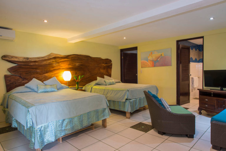 Bedroom with two beds and seating area in Manuel Antonio Costa Rica villa