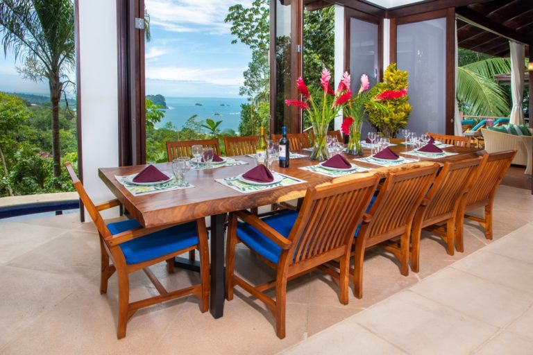 Dining table with ocean view through open glass doors in Manuel Antonio Costa Rica