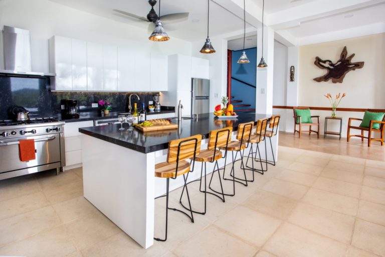 Modern kitchen with large island and bar seating in Manuel Antonio Costa Rica villa