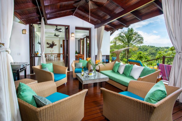 Outdoor living room with seating on terrace overlooking tropical landscape in Manuel Antonio Costa Rica