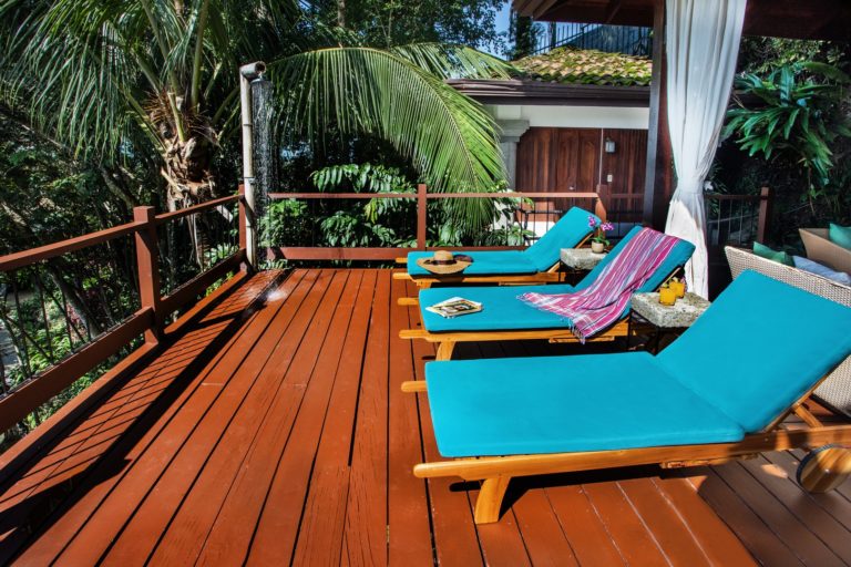 Pool deck with lounge chairs and tropical vegetation in Manuel Antonio Costa Rica