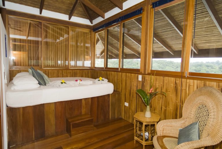 Elevated bedroom with wood interior and jungle views in Manuel Antonio Costa Rica