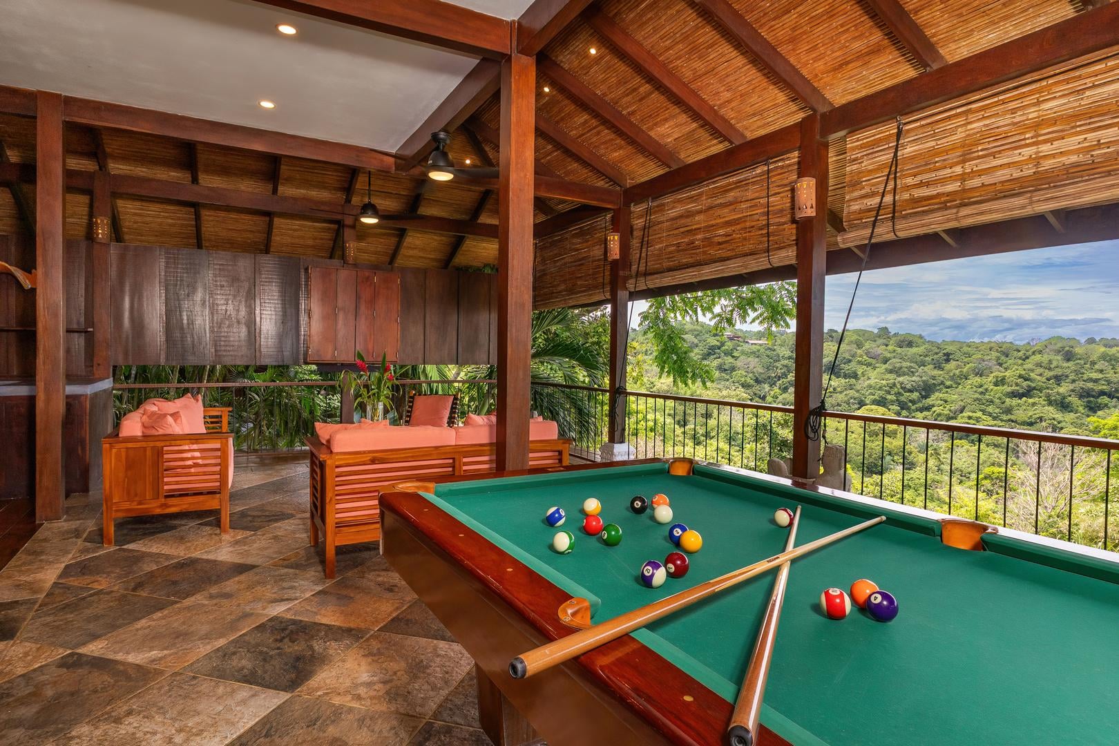 Open-air entertainment room with pool table and seating area in Manuel Antonio Costa Rica