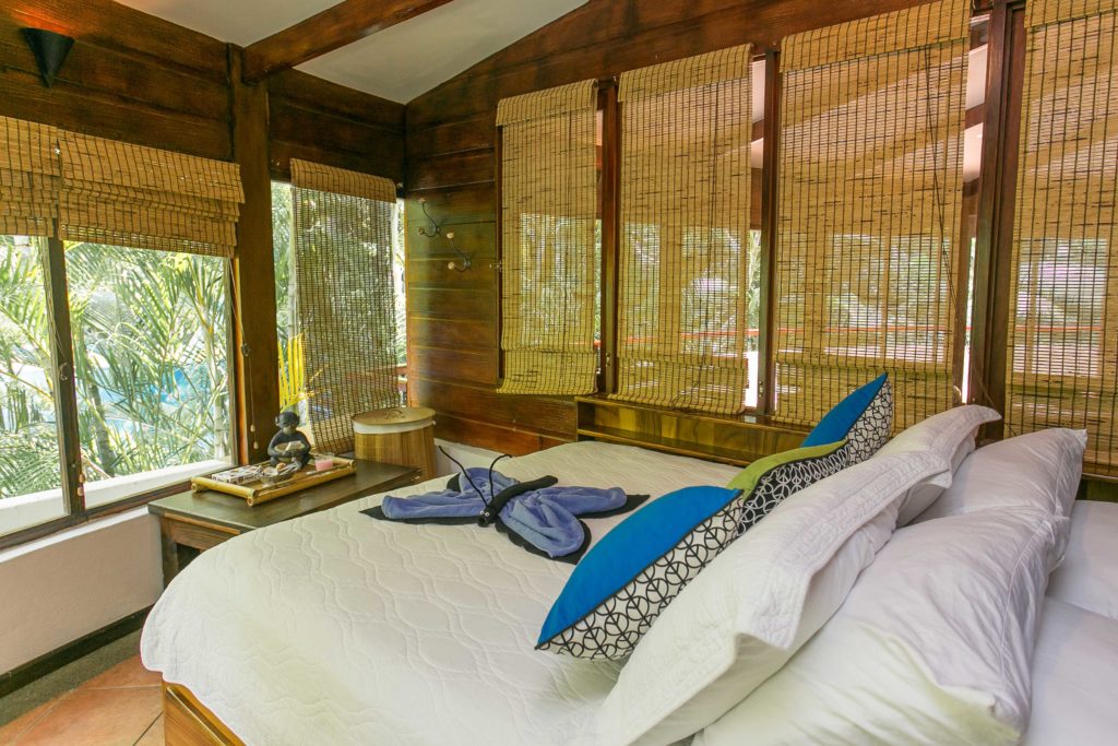 This queen bedroom has large picture windows that can be closed with drop shades.