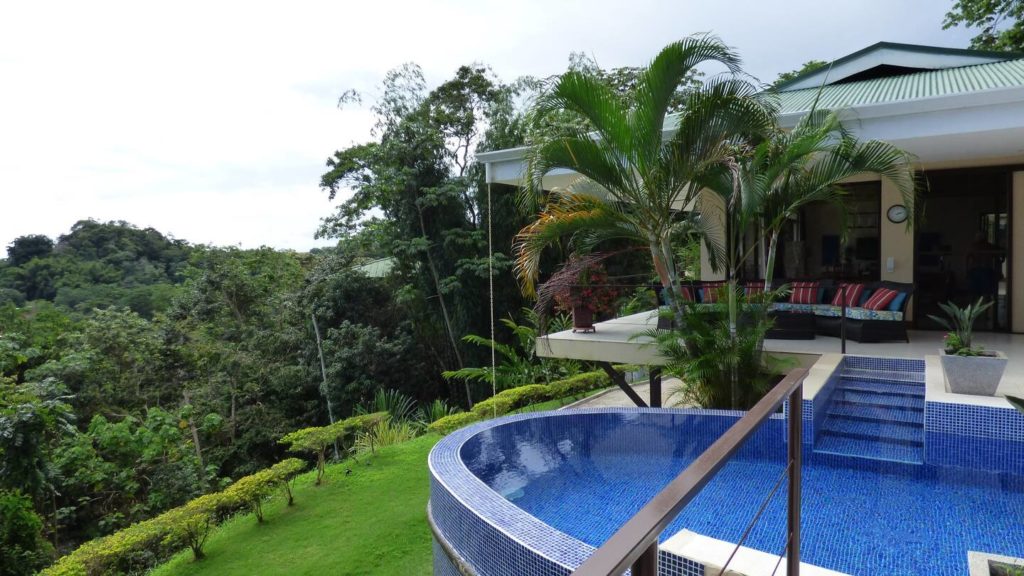 The open-plan living area has incredible rainforest views and the refreshing infinity pool is just outside.