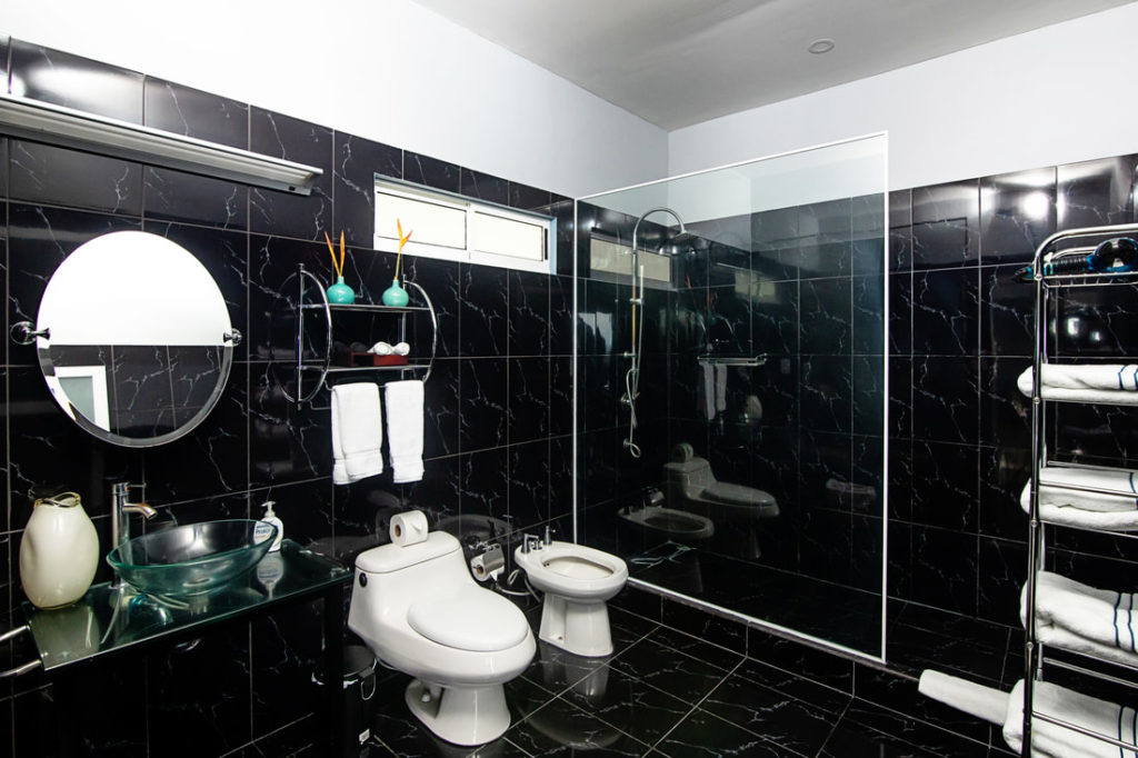 Indulge in the opulence of this exquisite bathroom as you prepare for a night on the town in Manuel Antonio.