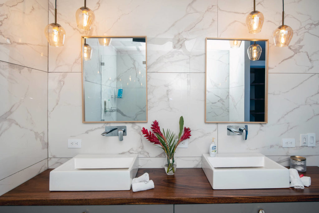 Elegantly simple his and hers sinks adorn the bathroom.