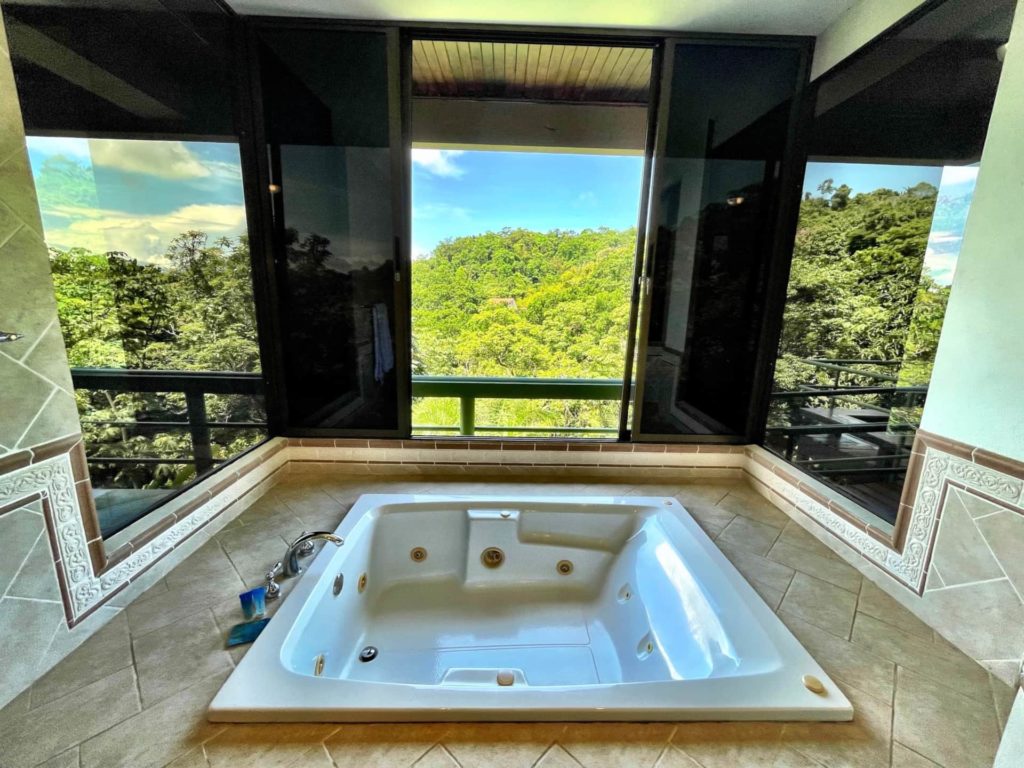 The master ensuite bathroom offers a serene retreat, allowing you to unwind fully in the jetted whirlpool tub while enjoying picturesque mountain views.