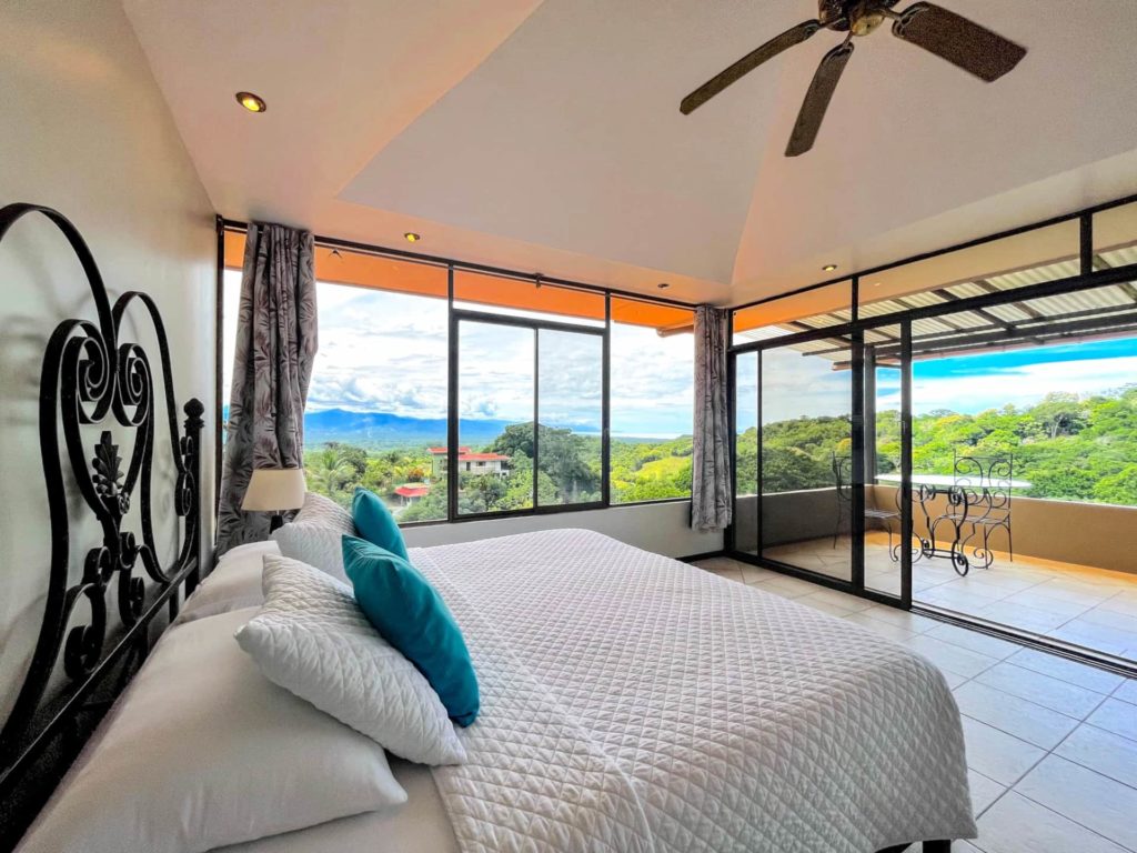 
Embrace the breathtaking views from this bedroom, where expansive sliding doors invite invigorating tropical breezes indoors.