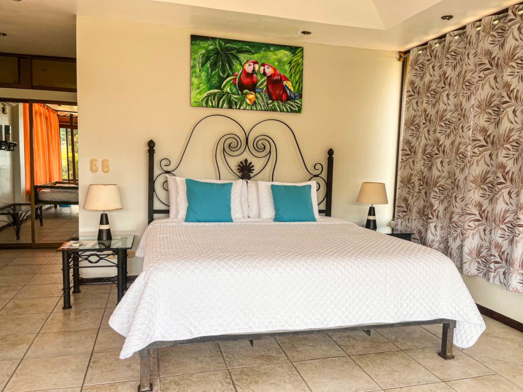 This bedroom is adorned with local art and handcrafted details, enhancing its tropical charm and creating a unique ambiance throughout.
