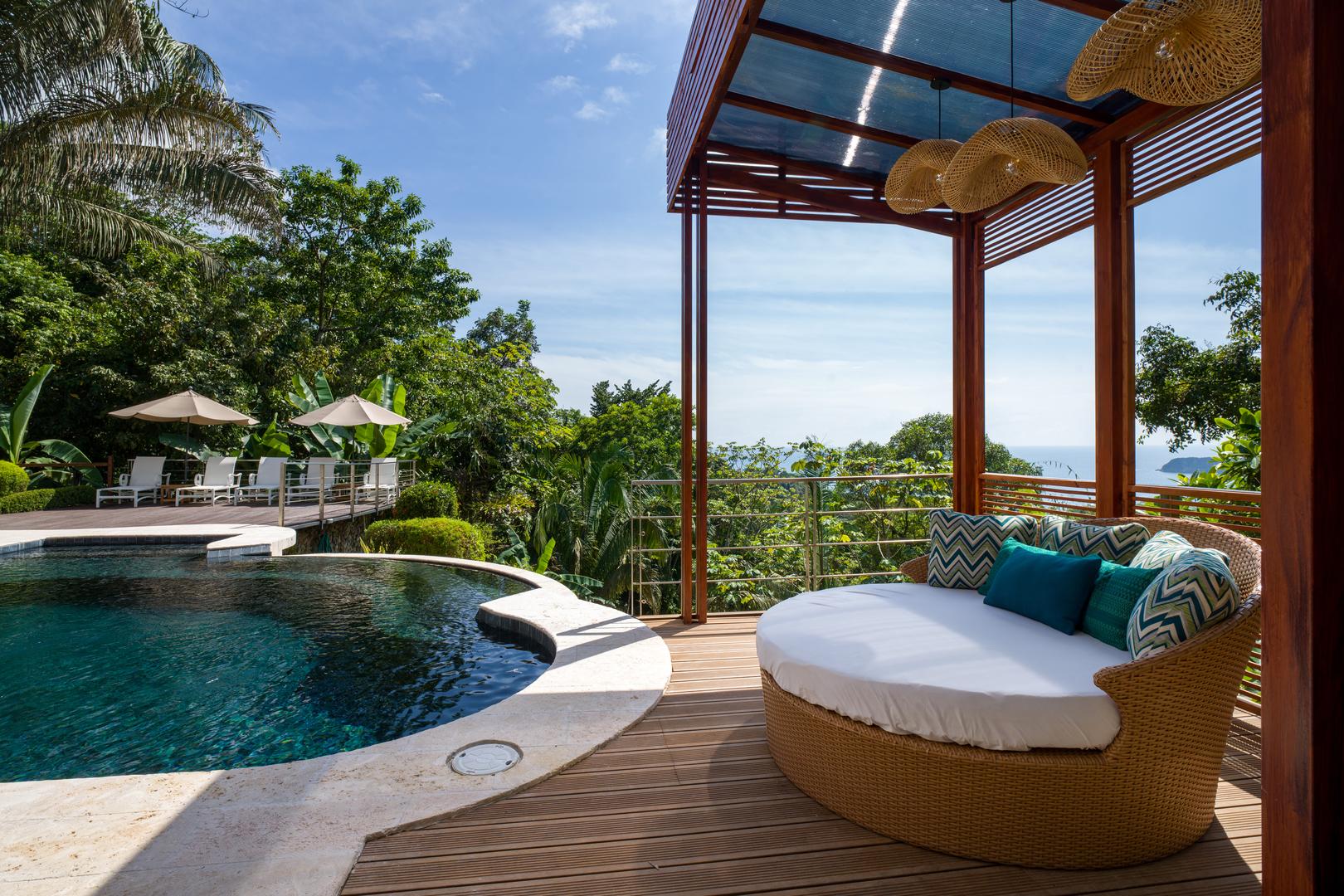 shaded-poolside-lounge-with-jungle-and-ocean-horizon