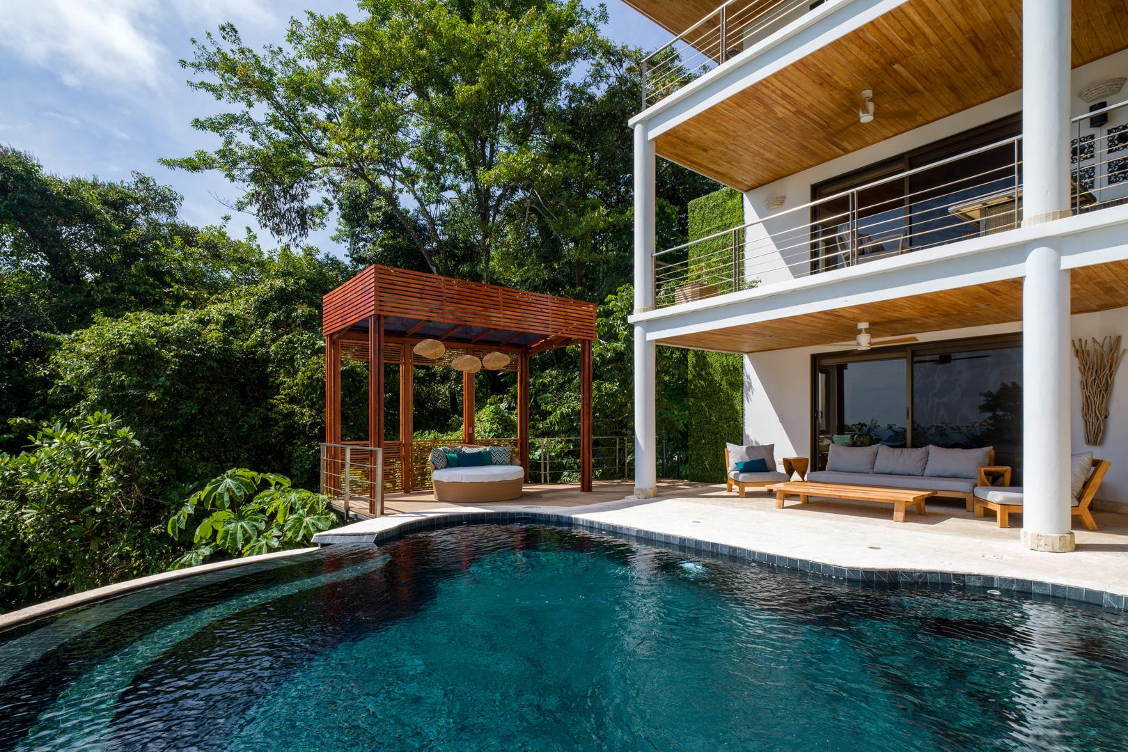 elegant-pool-terrace-with-jungle-and-shaded-lounges
