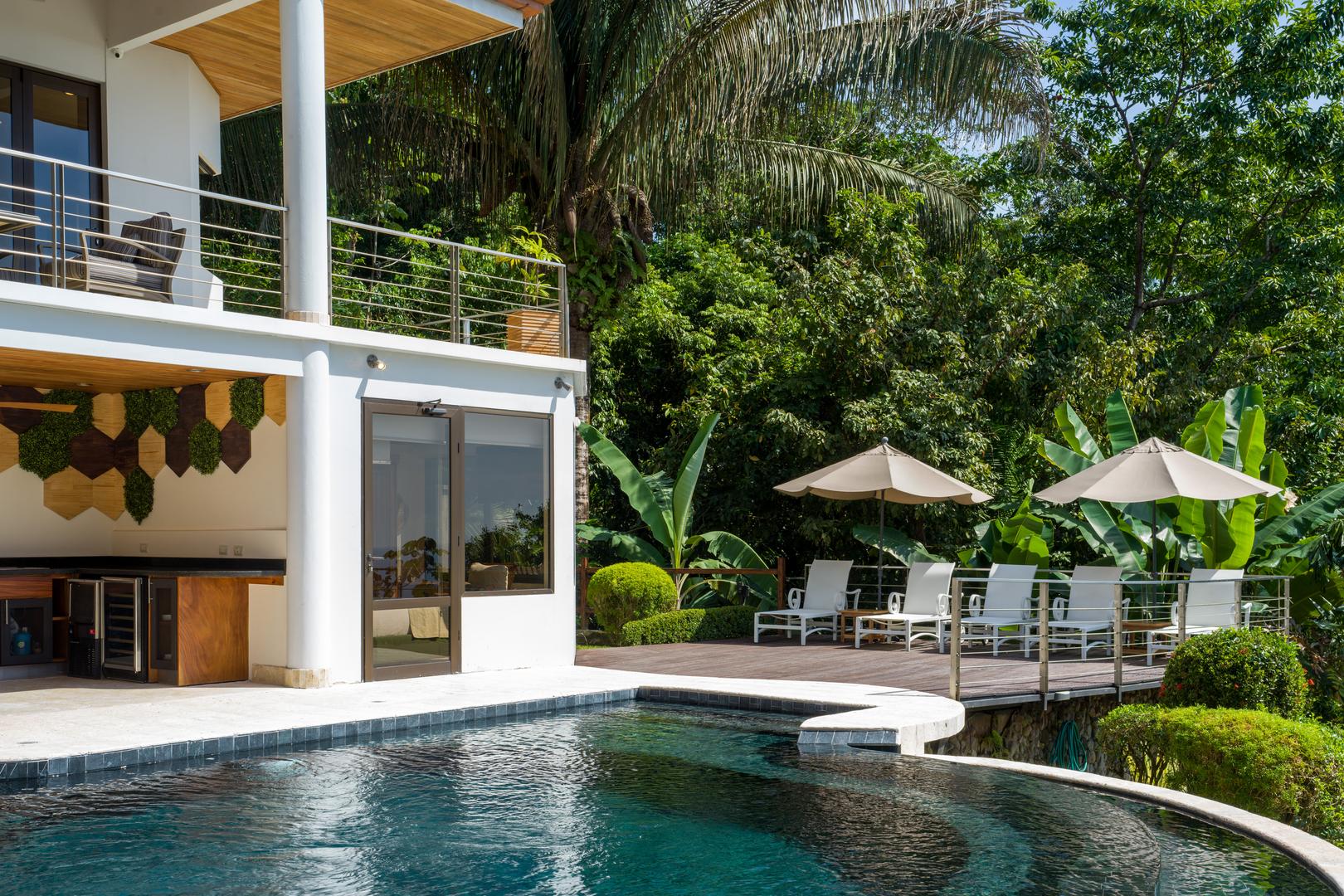 sunlit-poolside-area-with-bar-and-loungers