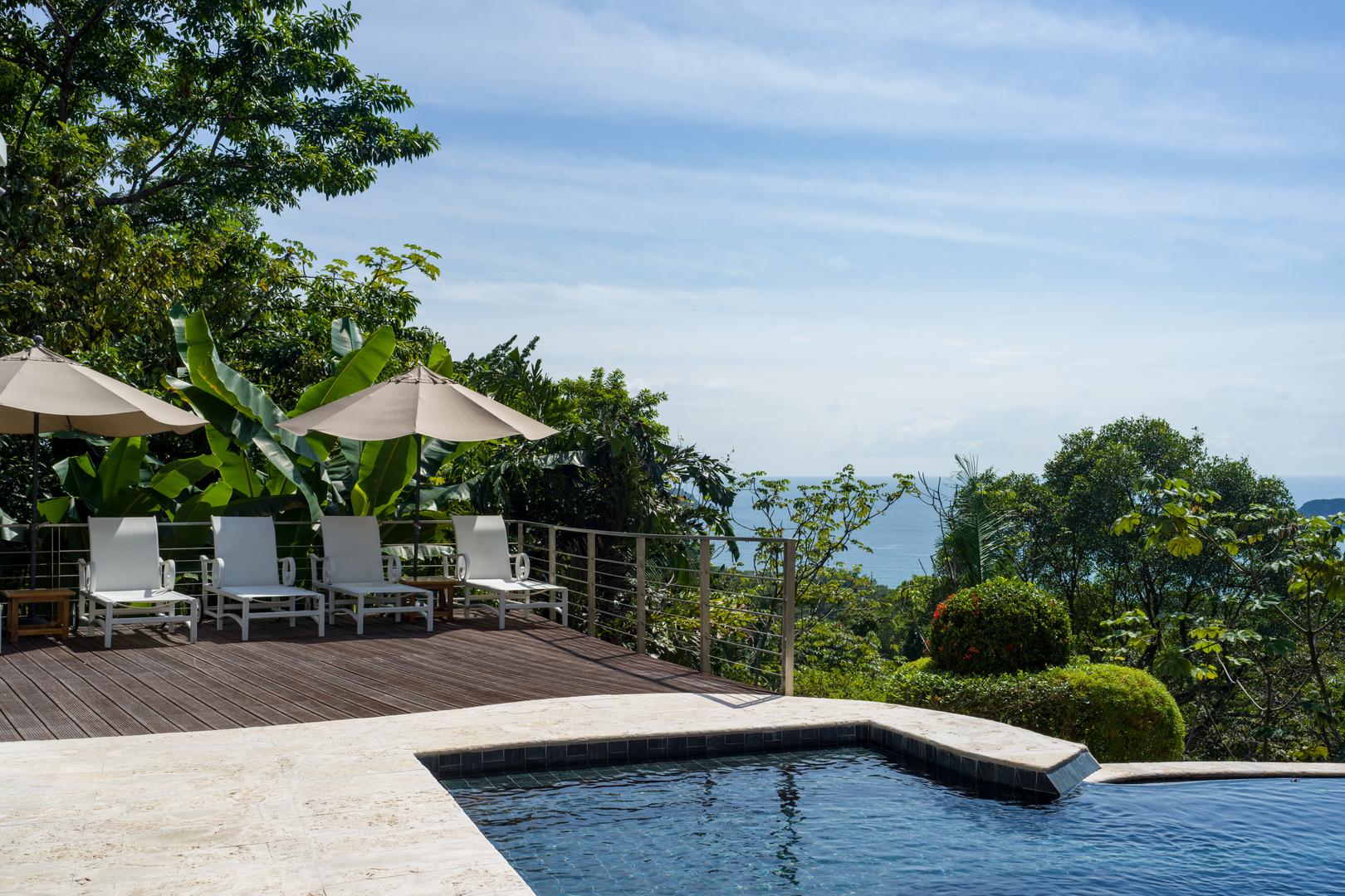 poolside-loungers-with-garden-setting-and-ocean-vistas