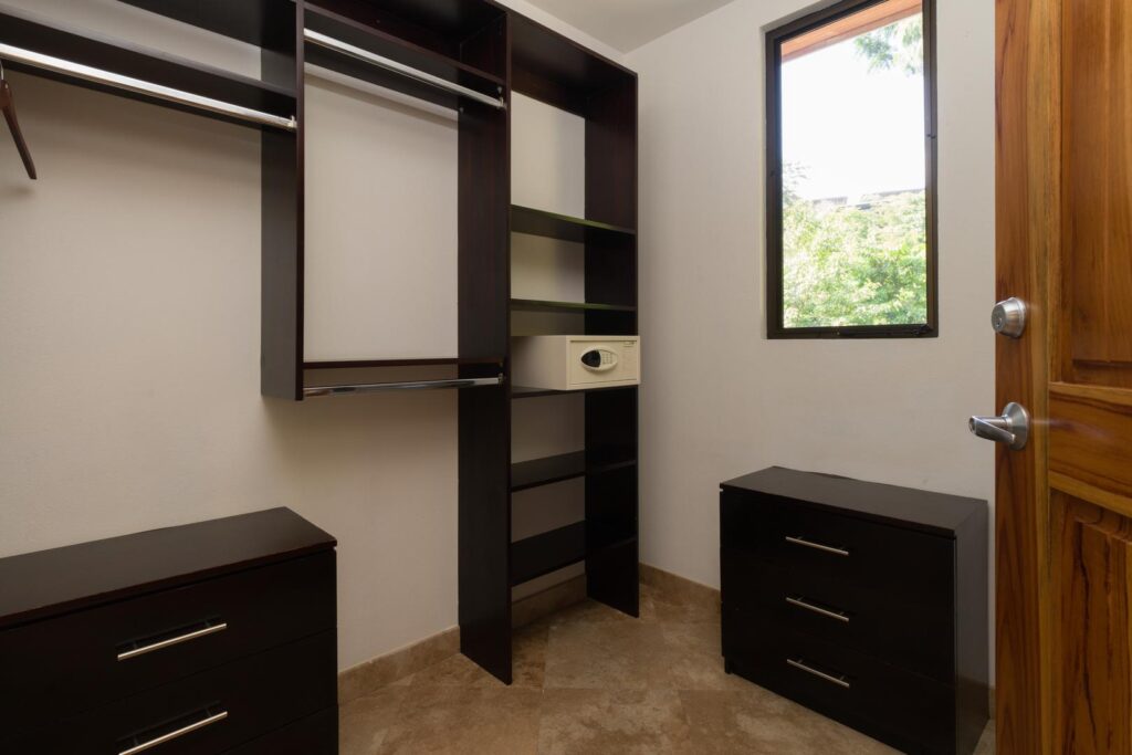 A well-designed walk-in closet with generous shelving, drawers, and hanging space, giving you plenty of room to settle in comfortably.