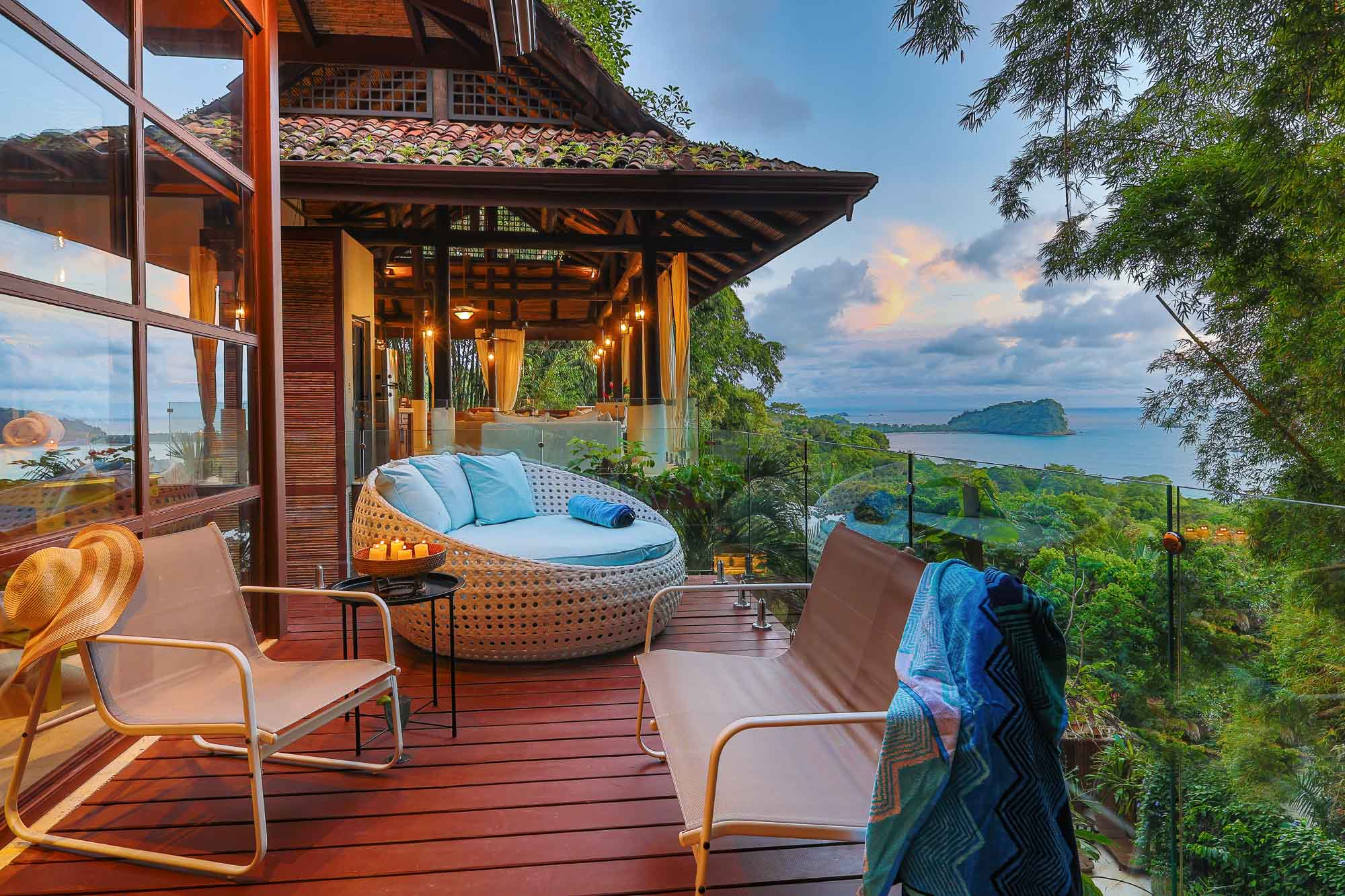 Outdoor deck at sunset with seating and ocean views from the new wing of a Manuel Antonio villa.