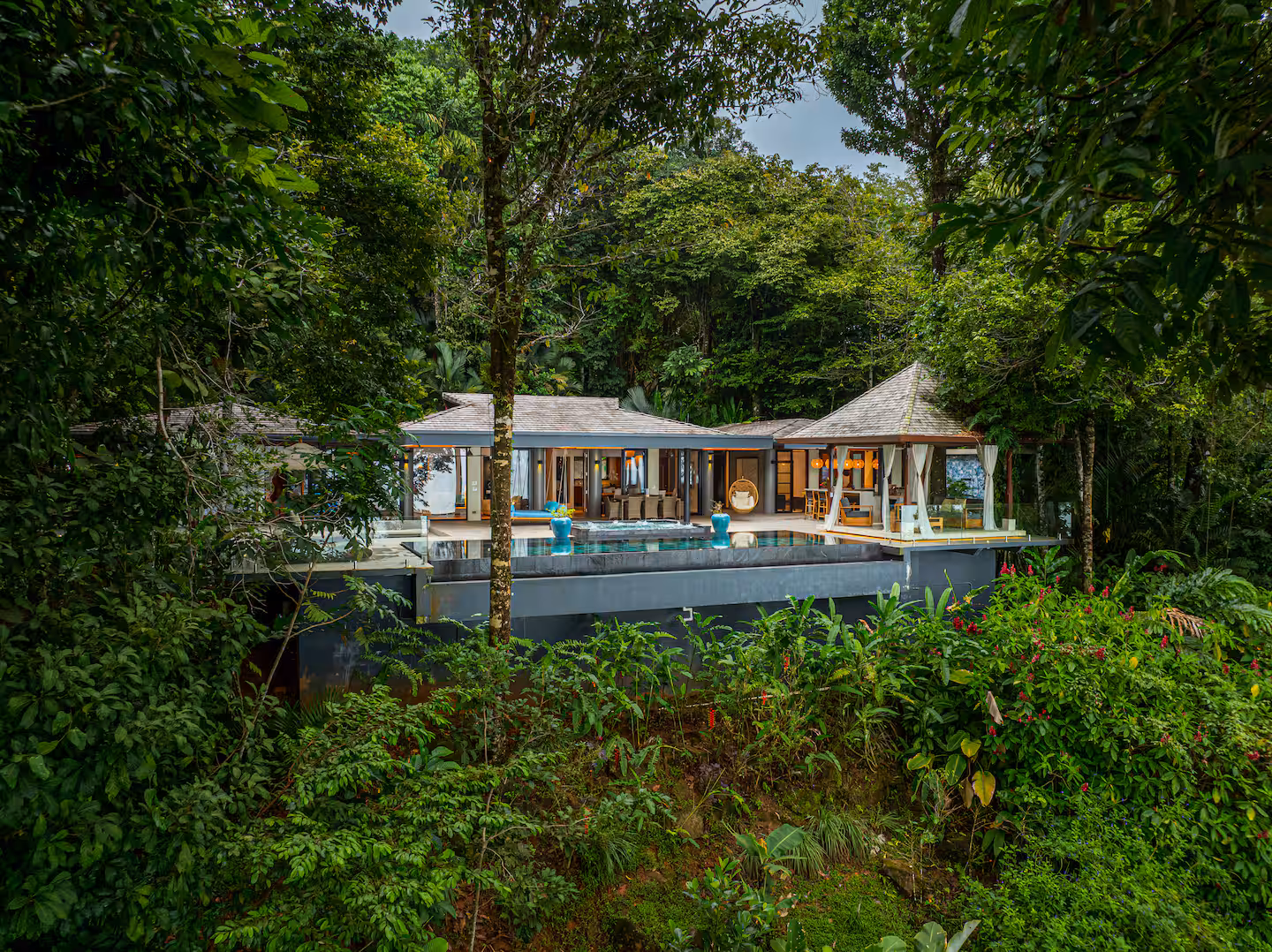 Outdoor lounge seating surrounded by tropical jungle at a private luxury villa near Dominical, Costa Rica.