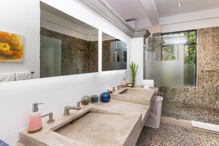 Bathroom with double vanity sinks and walk-in stone shower in Manuel Antonio Costa Rica