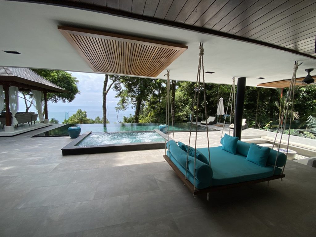 Floating bed overlooking the jacuzzi and infinity pool, all with a breathtaking ocean view.