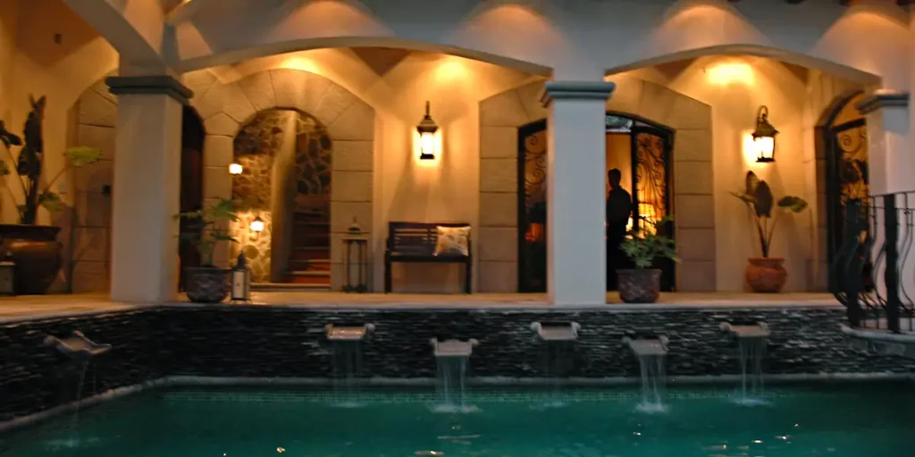 The elegant pool features graceful cascading water elements, enriching its serene atmosphere.



