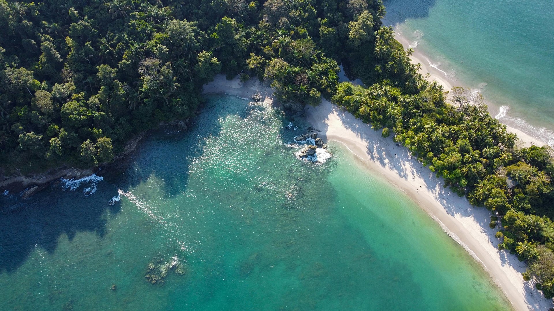 Aerial view of pristine white-sand beaches and tropical rainforest in Manuel Antonio National Park, Costa Rica.