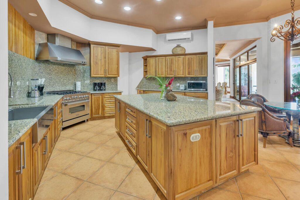 A roomy kitchen with modern amenities, featuring warm wood details and a big island for cooking together.