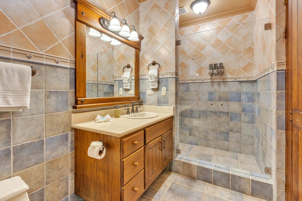 Simple comforts make this bathroom cozy and easy to use, with a step-in shower for convenience.