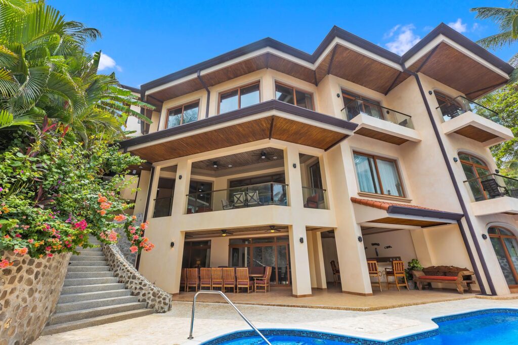 A large beachfront villa ideal for families or groups, featuring open, airy spaces and elevated views above the palms.