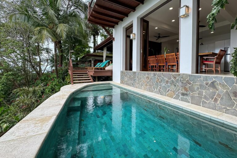 Private pool next to open living and dining area surrounded by tropical forest in Manuel Antonio Costa Rica