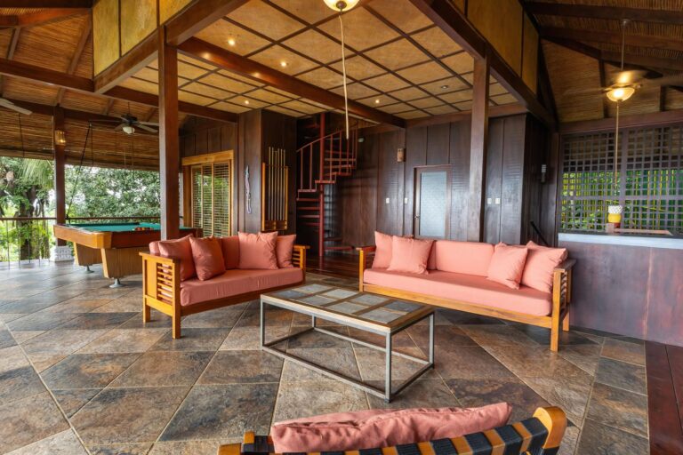Open-air lounge seating area with wooden interior and tropical surroundings in Manuel Antonio Costa Rica