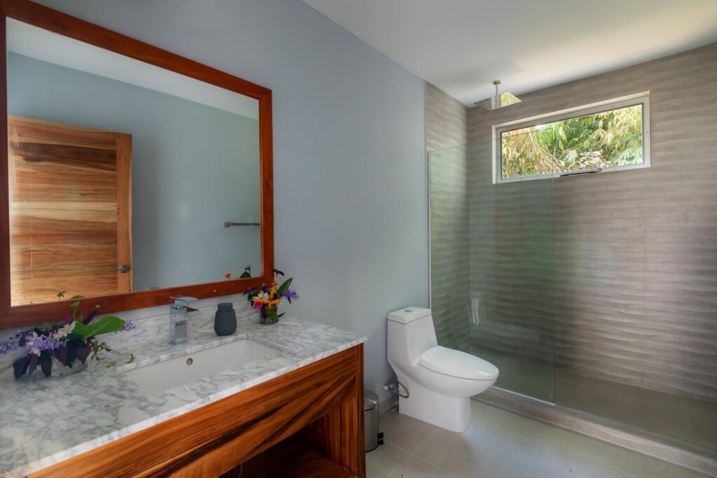 The beautiful natural theme flows into the design of the bathrooms.