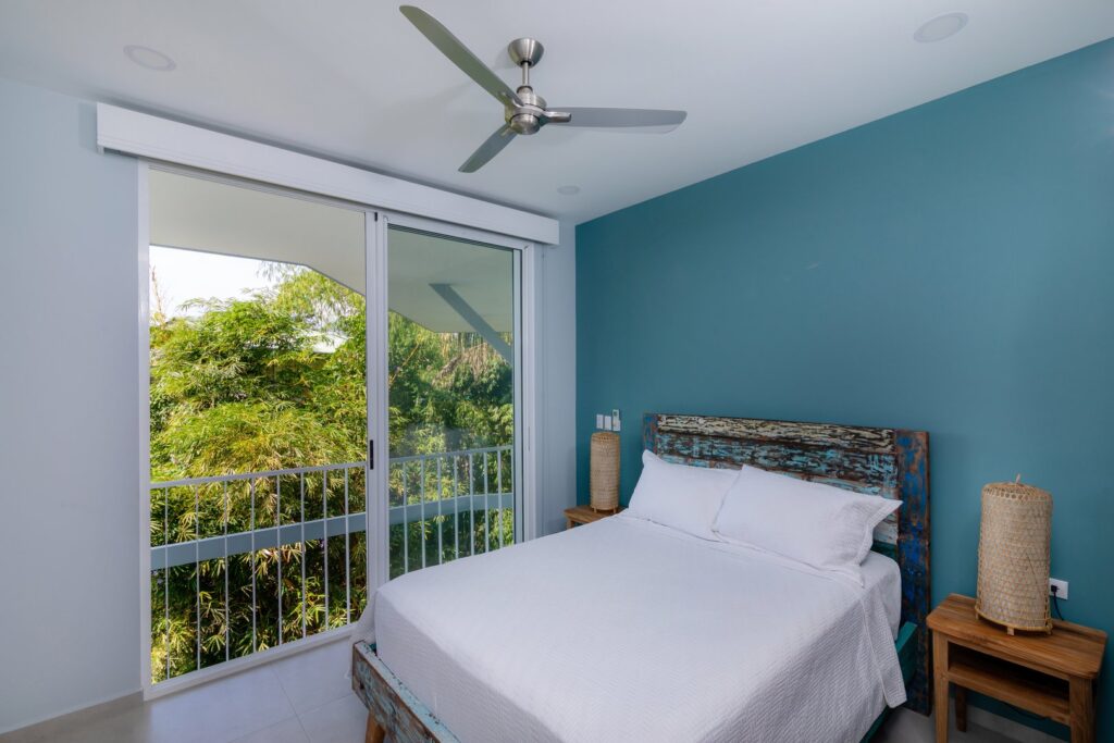 The jungle canopy lies just outside this bedroom with sliding doors open to let in the fresh tropical breeze.