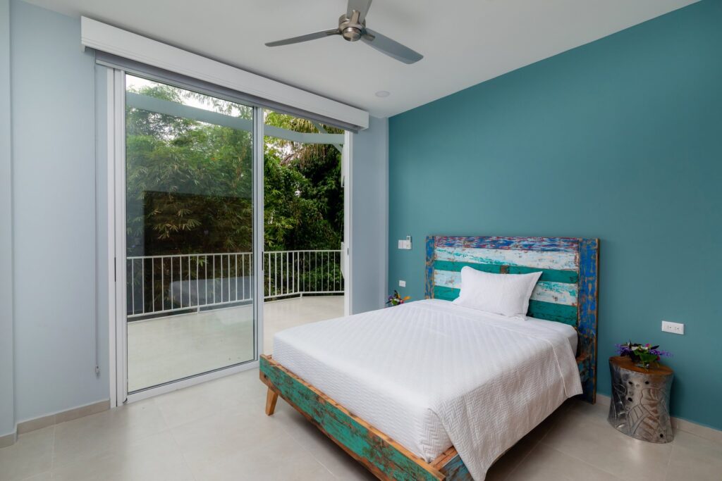 Direct balcony access in this relaxing blue bedroom.