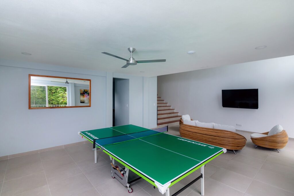 Table tennis and a large-screen TV provide some light entertainment in this modern open-plan living area.