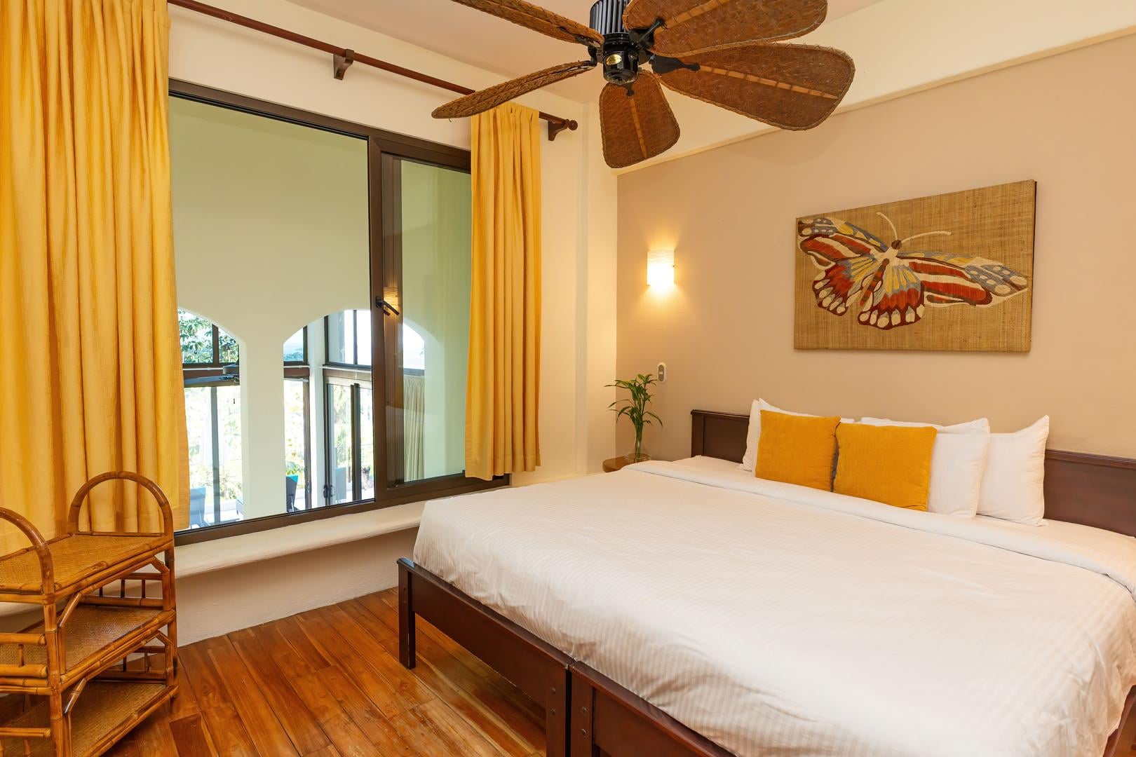 Bedroom with warm color accents, natural light, and comfortable bedding