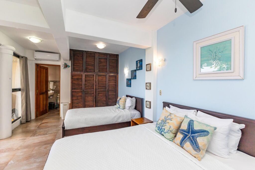 A bright twin bedroom styled with soft coastal tones, offering a relaxed and welcoming space that’s easy to settle into.