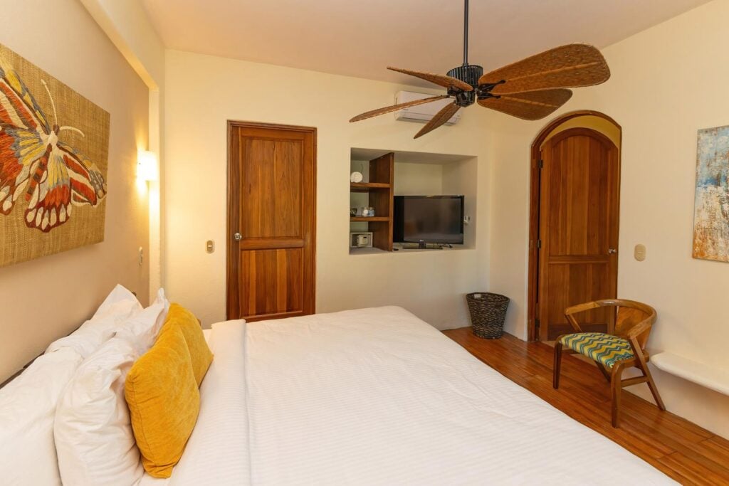 A comfortable bedroom accented with warm wood details and soft lighting, creating a soothing space to rest and unwind.