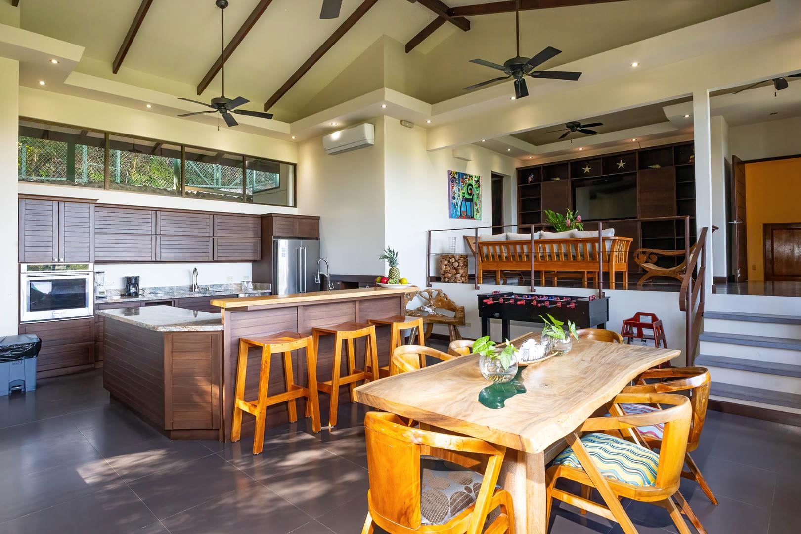 Open-plan living area combining kitchen, dining space, and entertainment area