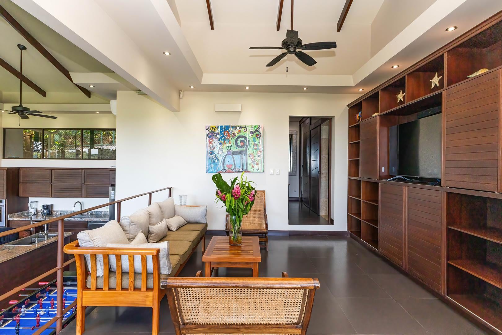 Upper-level entertainment lounge with seating, television, and open layout