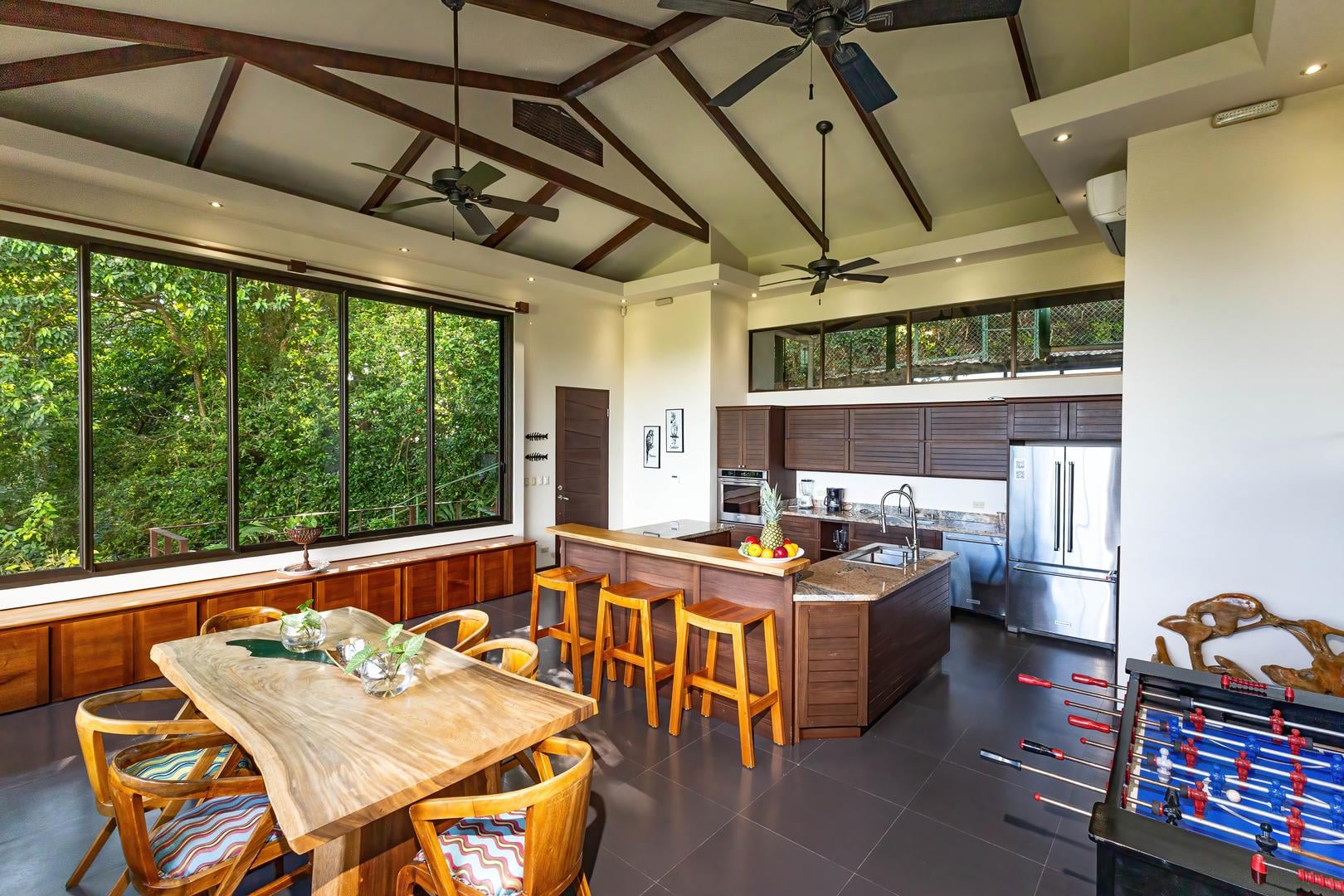Open-concept kitchen and dining area with jungle views and natural light