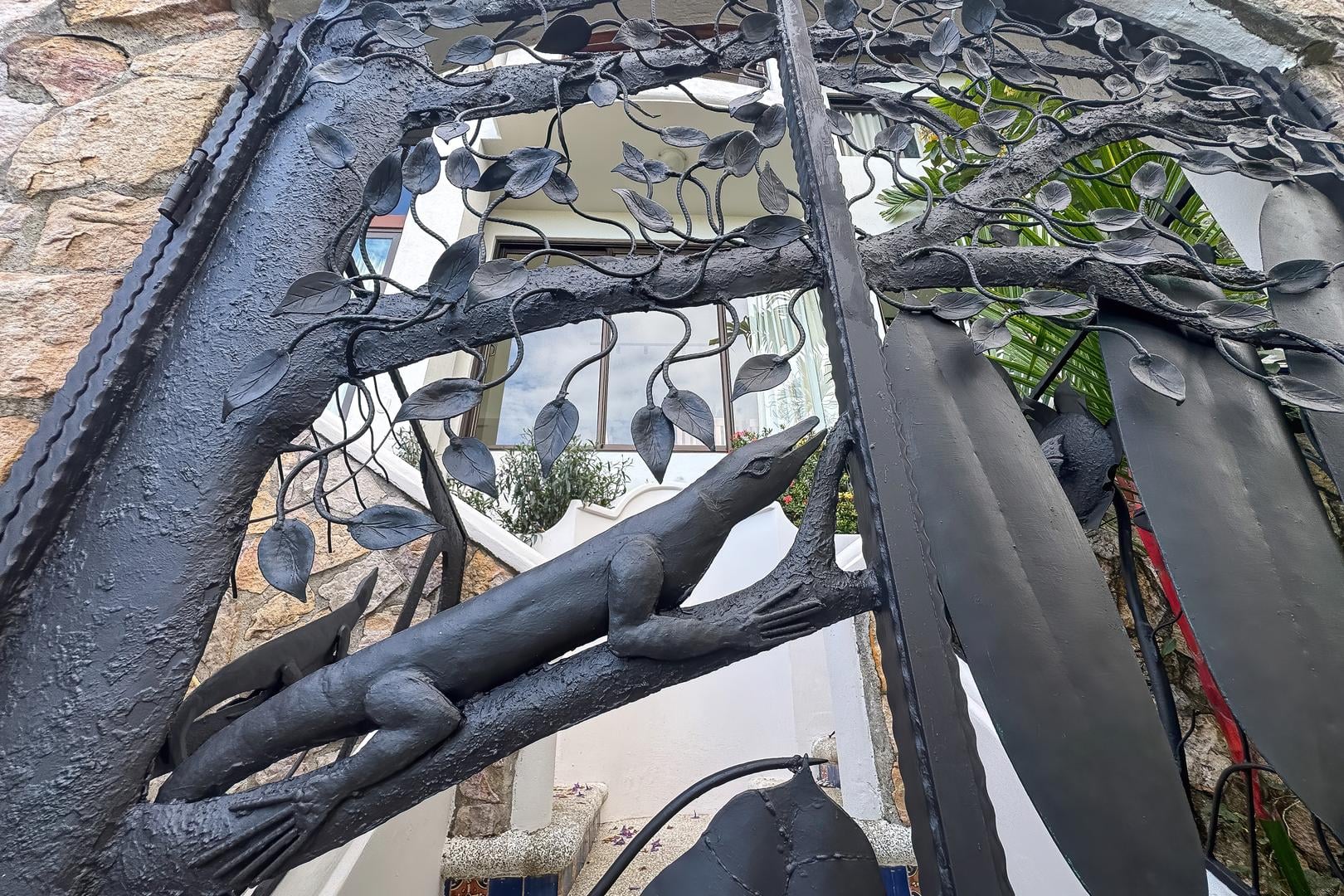 Custom iron entrance gate with decorative nature-inspired metalwork