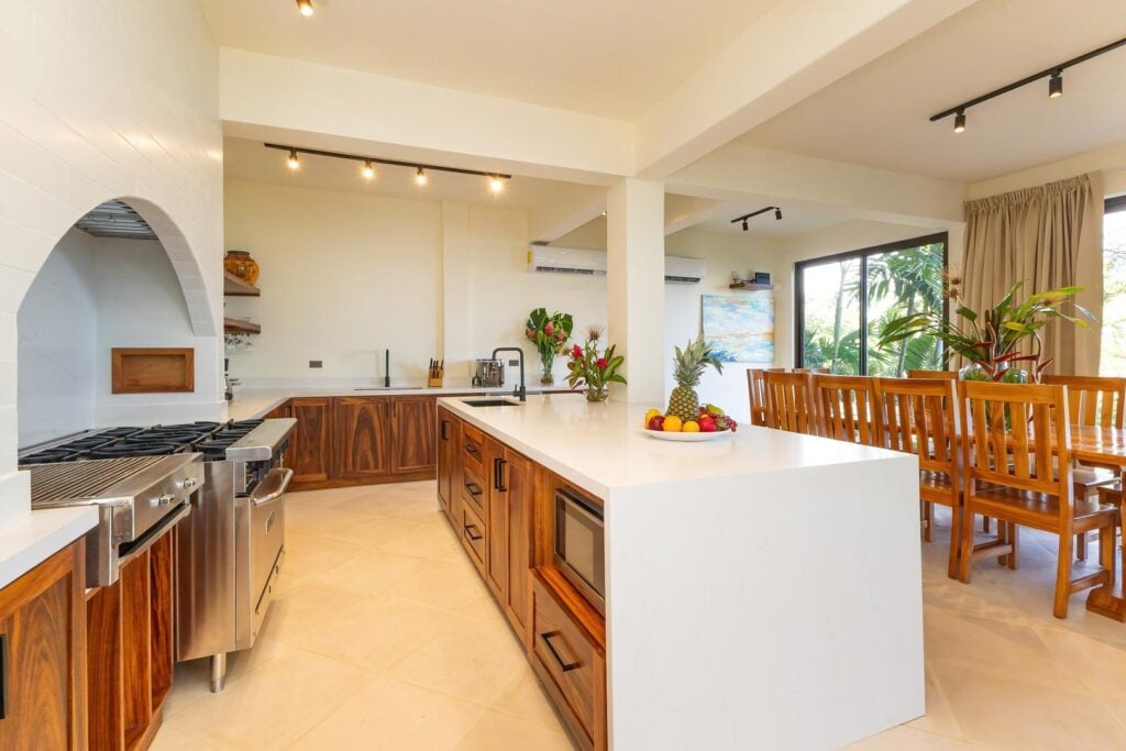 A modern open kitchen and dining space designed for gathering, where clean lines, warm wood finishes, and generous counter space invite easy meals and shared moments.
