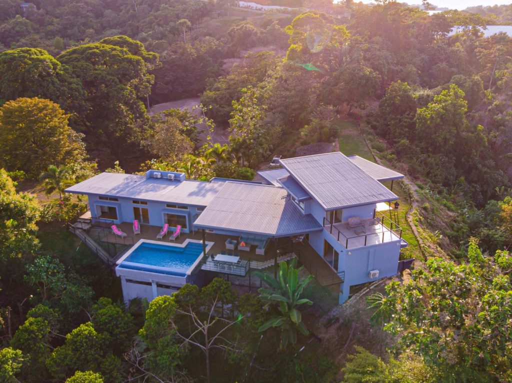 From above this luxury private house shows off its beautiful pool area.