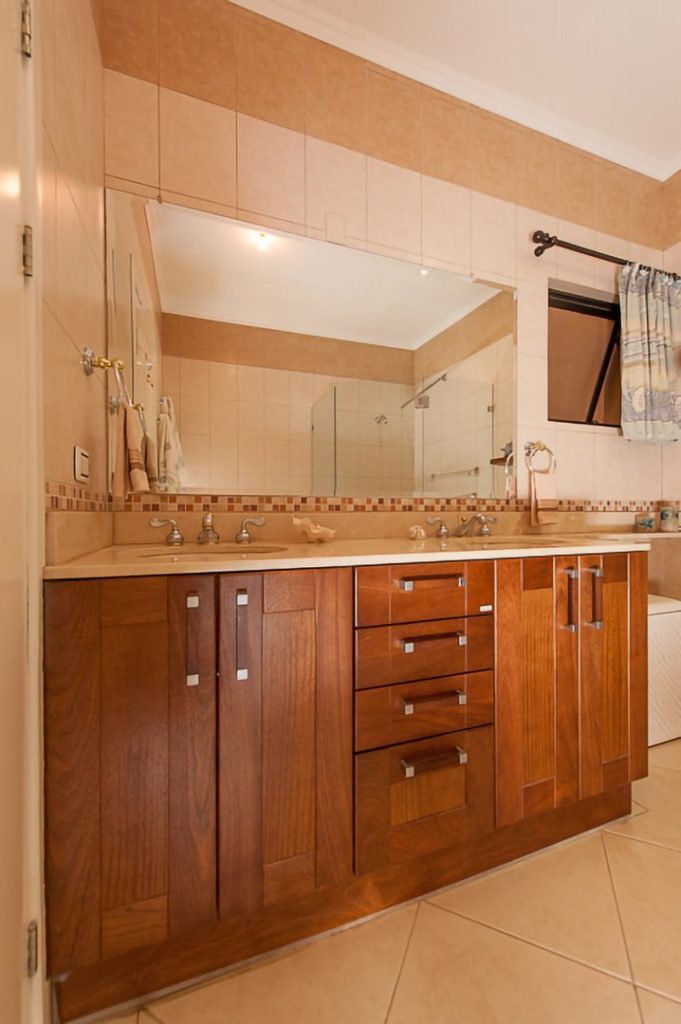 Tastefully-appointed wooden furniture compliments the ceramics in the bathrooms.