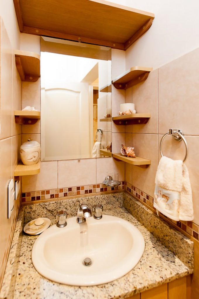 The shelves around the mirror in this bathroom add an elegant touch.