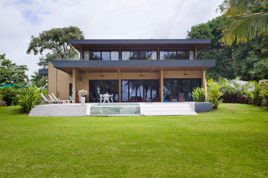 Contemporary beachfront vacation villa in Costa Rica featuring a private pool and lush tropical gardens.