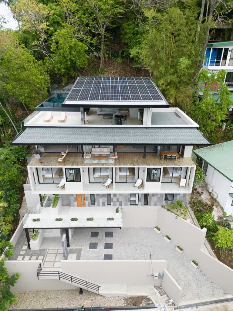 The elegant architecture of this six-bedroom vacation home is incredible with solar panels and a rooftop infinity pool.